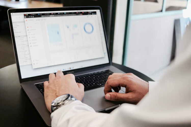 employee looks at data visualizations on his computer