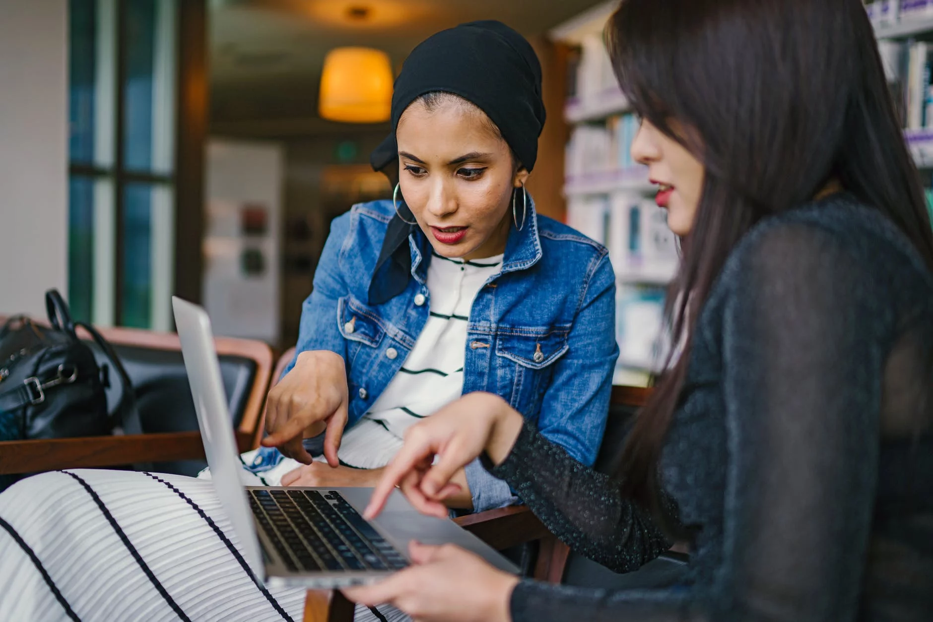 Two employees point to csv files on a computer