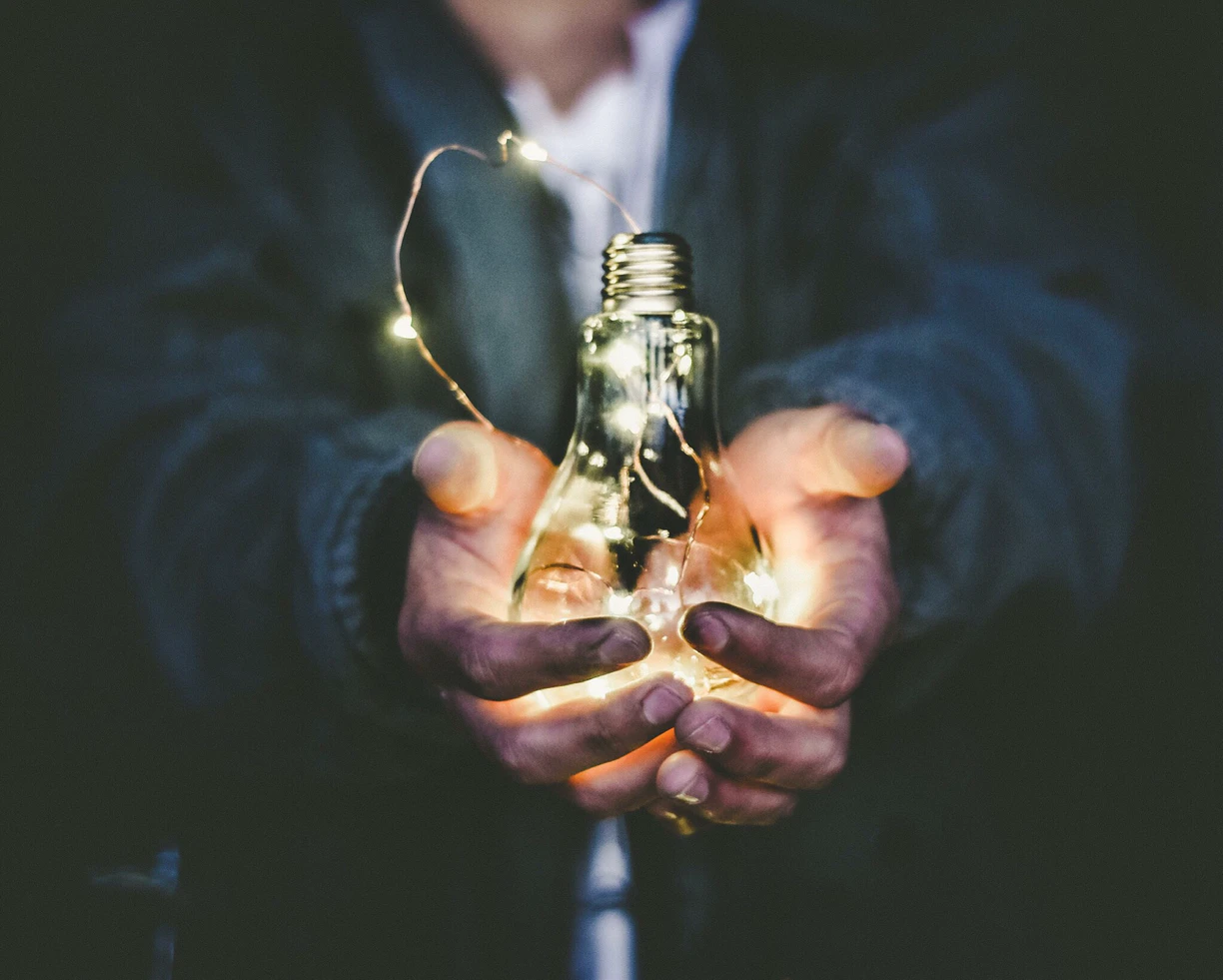 Person holding a lightbulb
