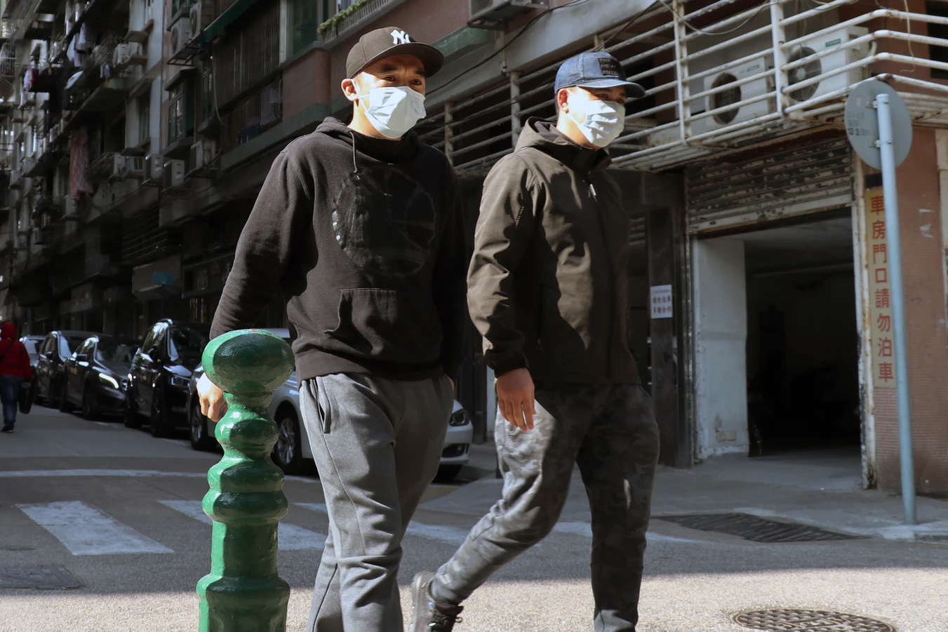 Two people wearing surgical masks